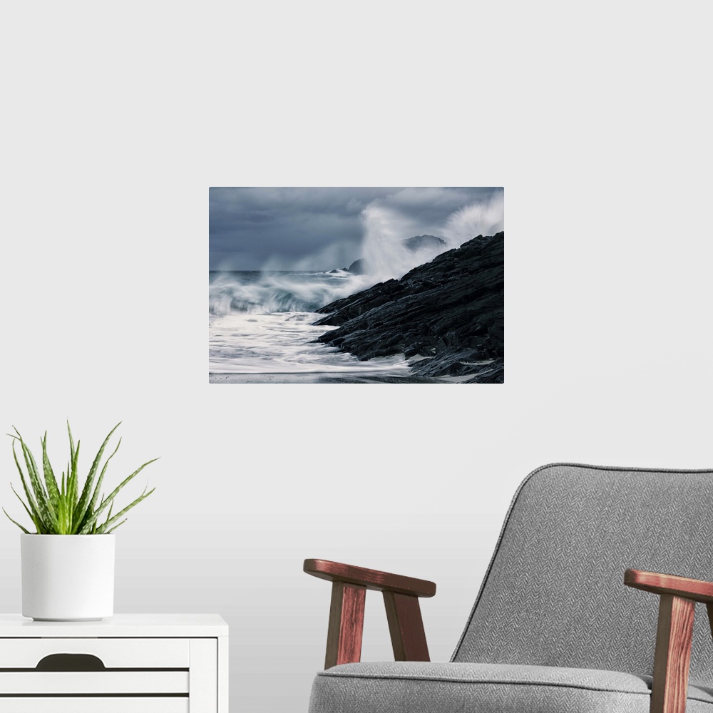 A modern room featuring Crashing waves on a stormy Scottish beach with dark rocks under grey sky