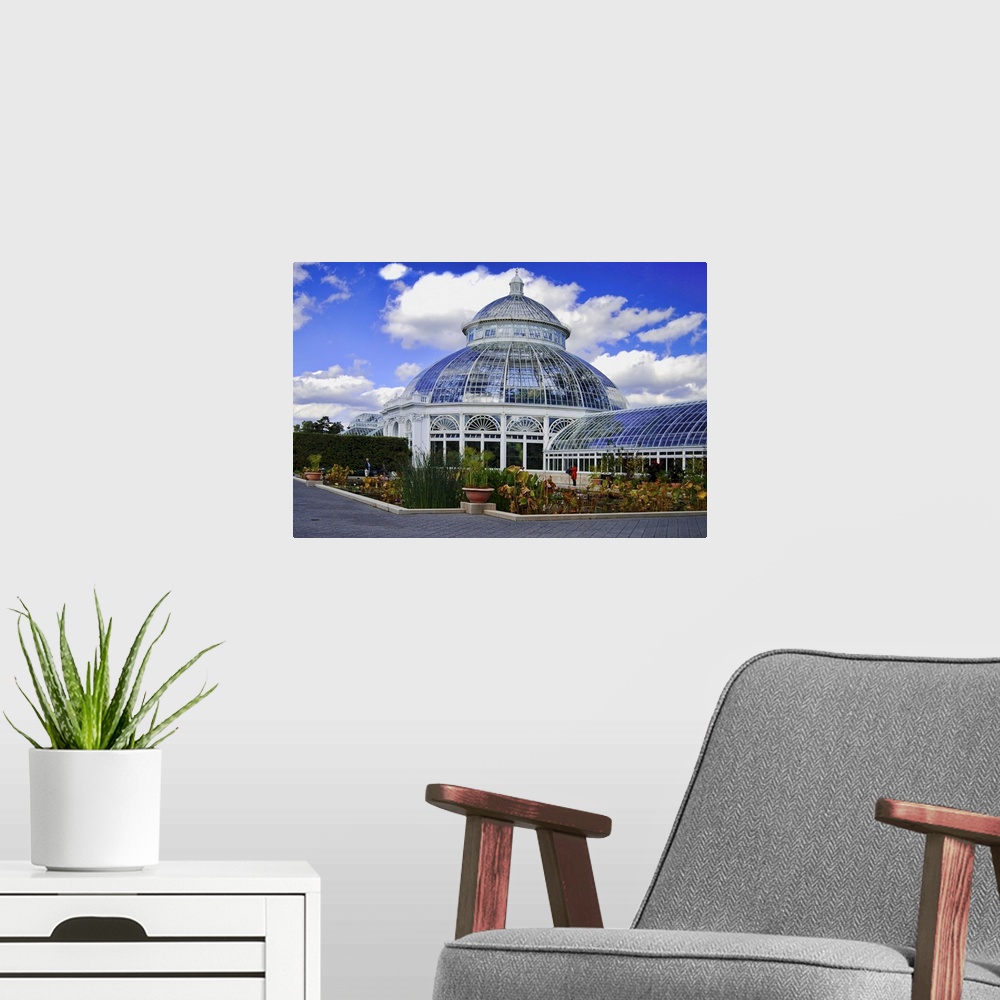 A modern room featuring The Palm House or Haupt Conservatory in the New York Botanical Gardens.