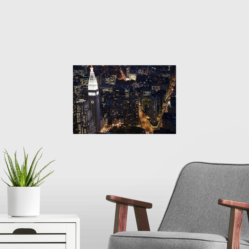 A modern room featuring The Flatiron building and the MLIT by night from the Empire State Building, NYC, USA