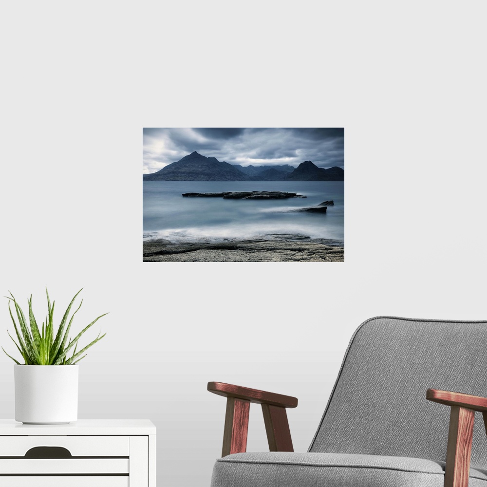 A modern room featuring Looking across the sea to the Isle of Skye with mountains under a grey sky