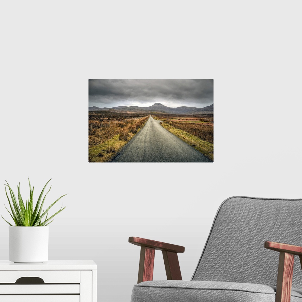 A modern room featuring Long straight road towards distant hills in Scotland, UK.