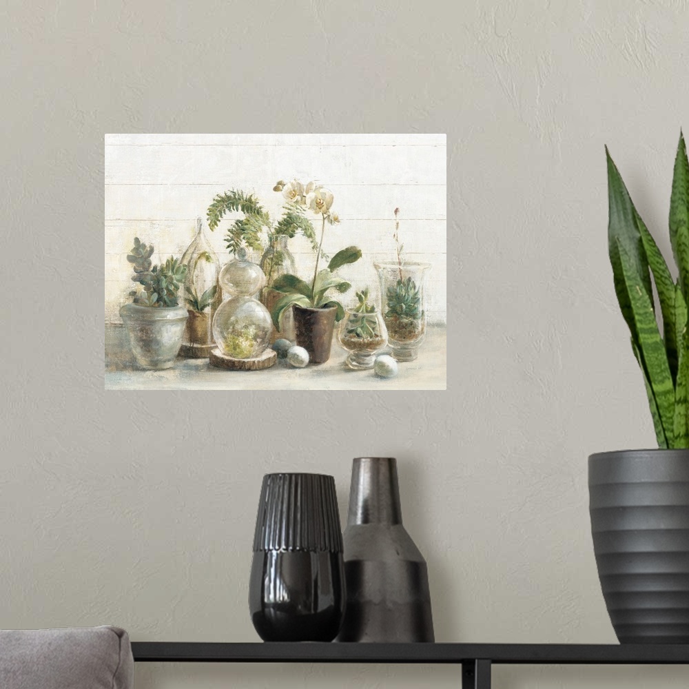 A modern room featuring A contemporary painting of a group of glass covered succulents and orchids against a white wood w...