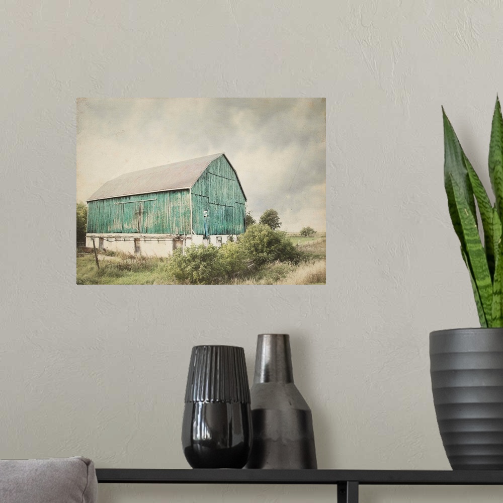 A modern room featuring Rustic photograph with distressed edges of an aged barn in a countryside landscape.