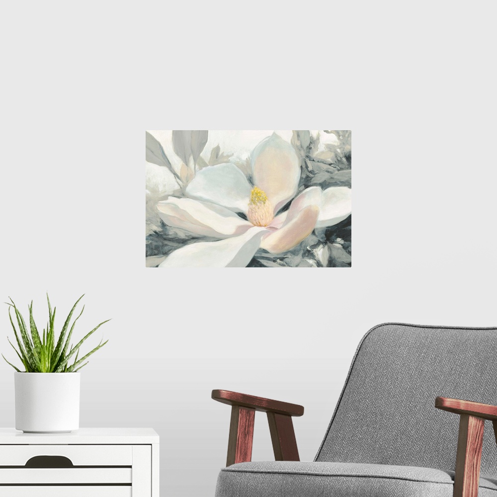 A modern room featuring A large close up painting of a magnolia bloom in shades of yellow, pink and gray.