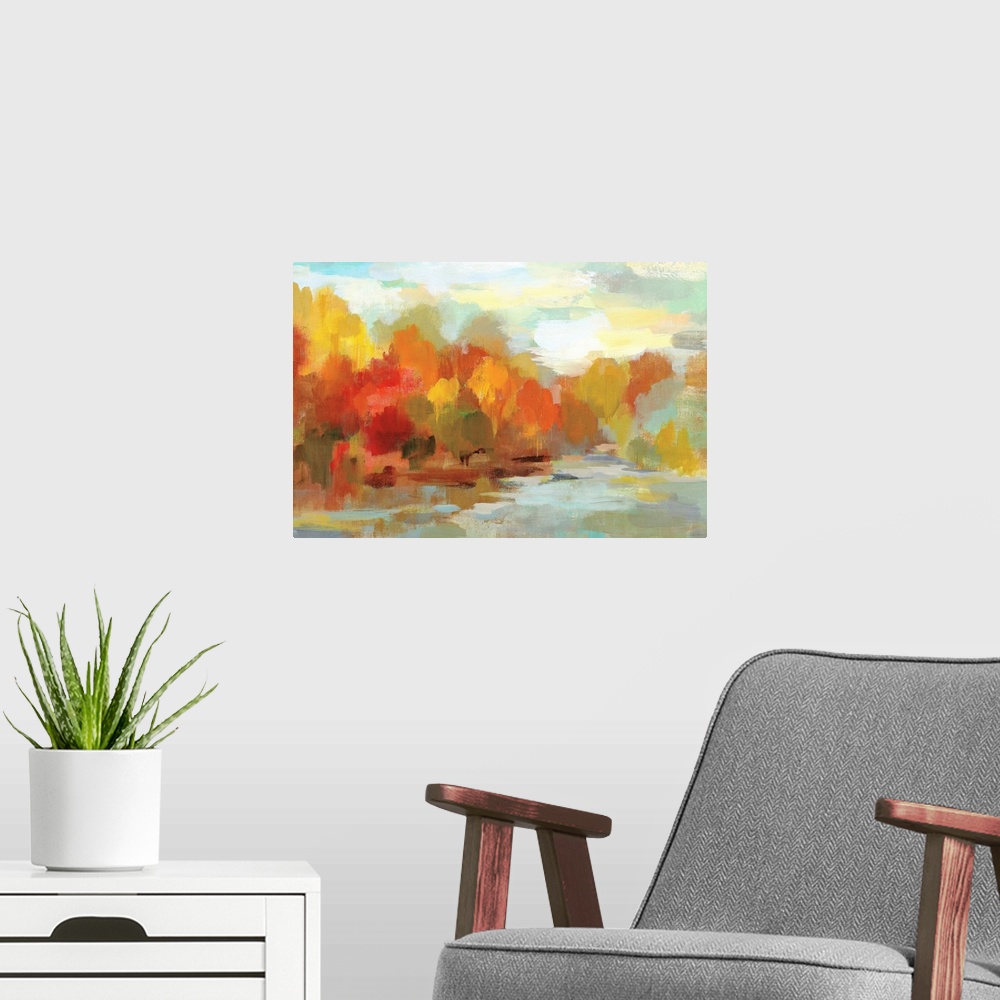 A modern room featuring Abstract painting of Fall trees and a blue sky made with short brushstrokes and many shades of co...