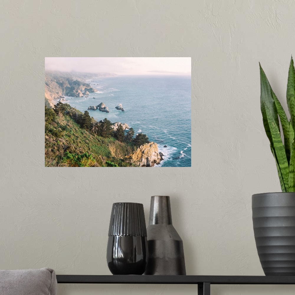 A modern room featuring A high angled photograph of the rocky cliffs of Big Sur, California.
