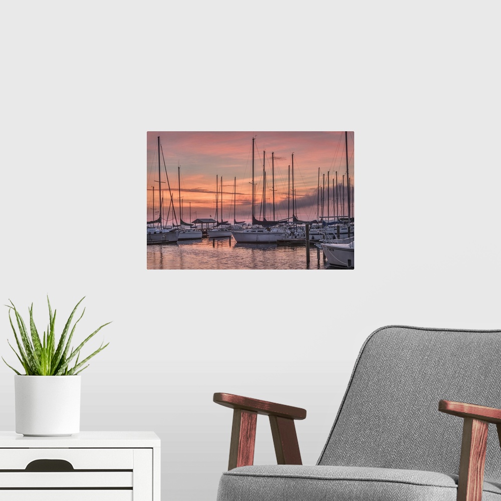 A modern room featuring A serene photo featuring sailboats huddled in a marina while the sun rises in the background
