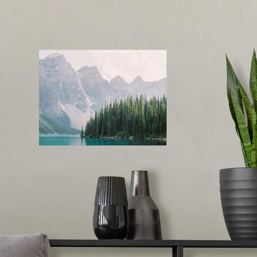 A modern room featuring Photograph of tall evergreen trees at the edge of a clear blue lake, Moraine Lake, Banff national...