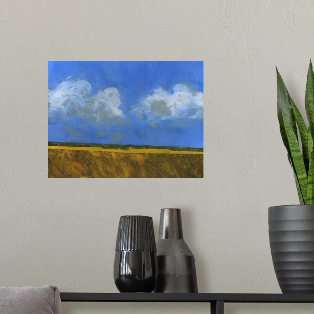 A modern room featuring Contemporary painting of an open landscape with a large blue sky with several clouds.