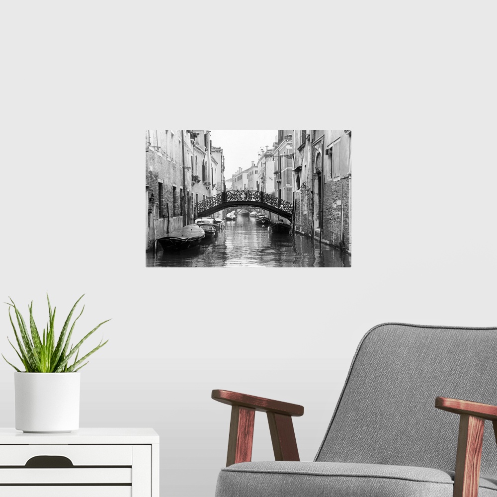 A modern room featuring Large photo on canvas of gondolas lining a canal in Venice.
