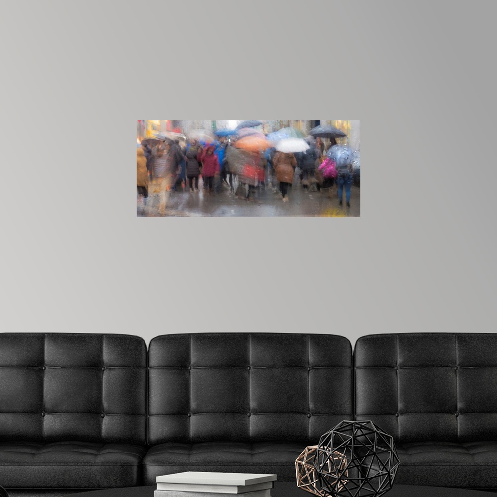 A modern room featuring A contemporary slow shutter speed photograph of people walking with umbrellas in the rain