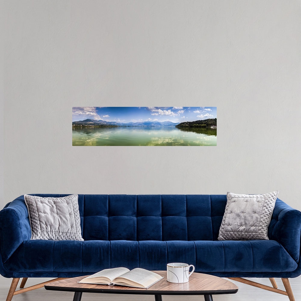 A modern room featuring Panoramic view of Kastoria lake under blue sky, Greece.
