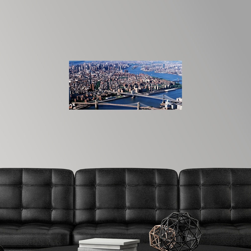 A modern room featuring Aerial panorama of suspension bridges and bustling New York City metropolis.