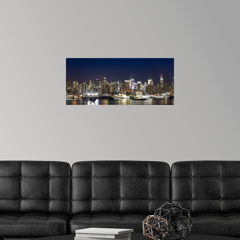 A modern room featuring Panoramic photograph showcases a busy skyline filled with skyscrapers as they shine brightly in t...