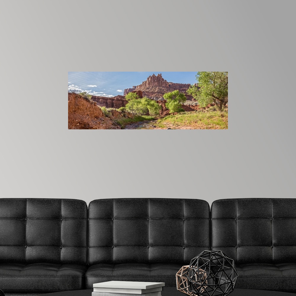 A modern room featuring View of 'The Castle' rock formation near a stream at Capitol Reef National Park.