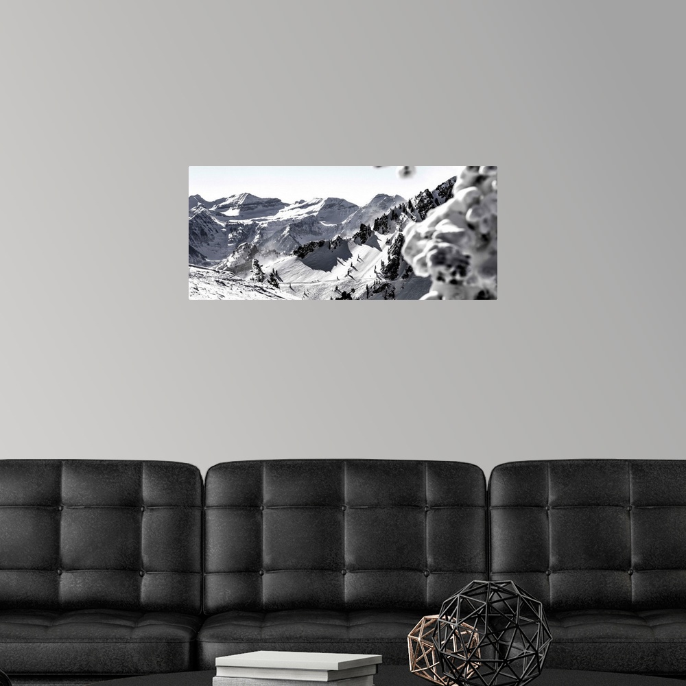 A modern room featuring Black and white landscape photograph of the Wasatch Range in Utah with a skier hiking up in the m...