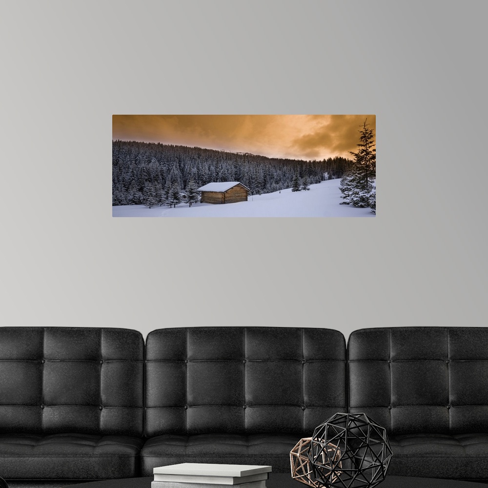 A modern room featuring Farm hut and forest in winter, dolomite mountains, Alta Badia, south Tyrol, Italy.