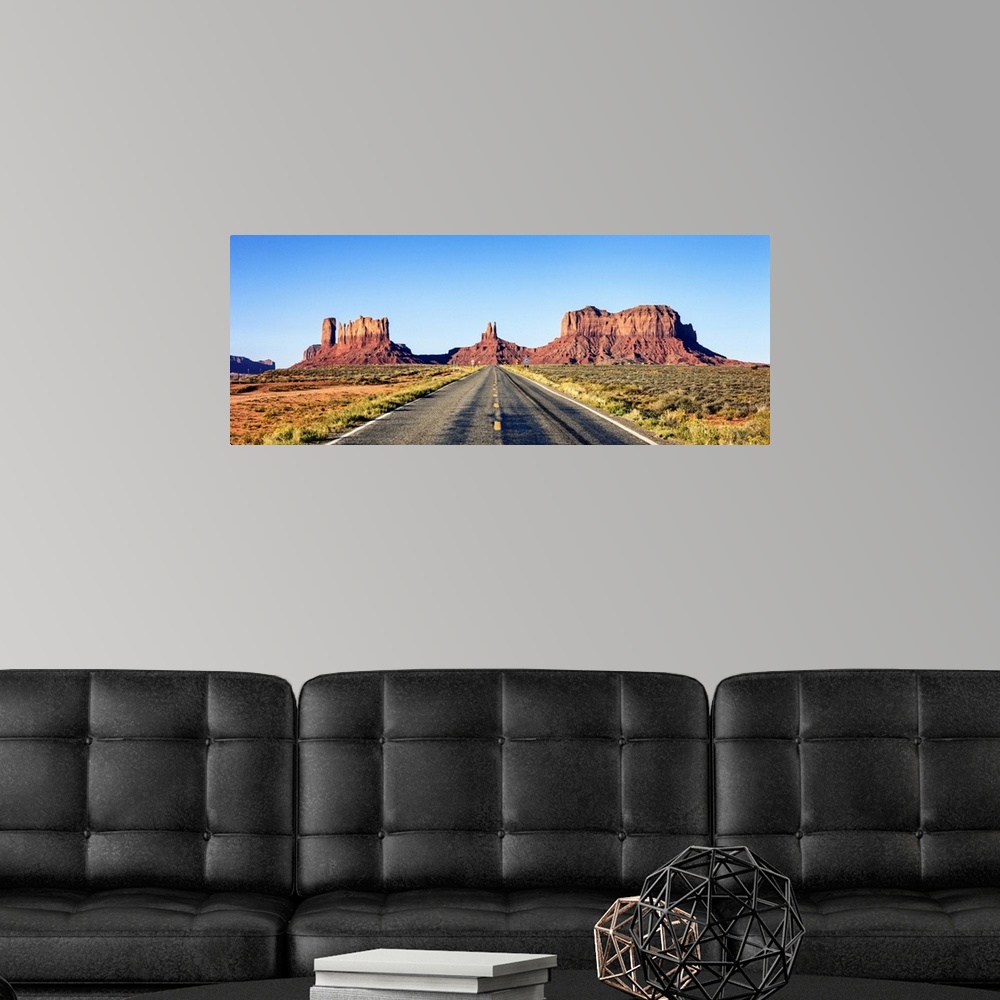 A modern room featuring Panoramic view of long road at monument valley, USA.