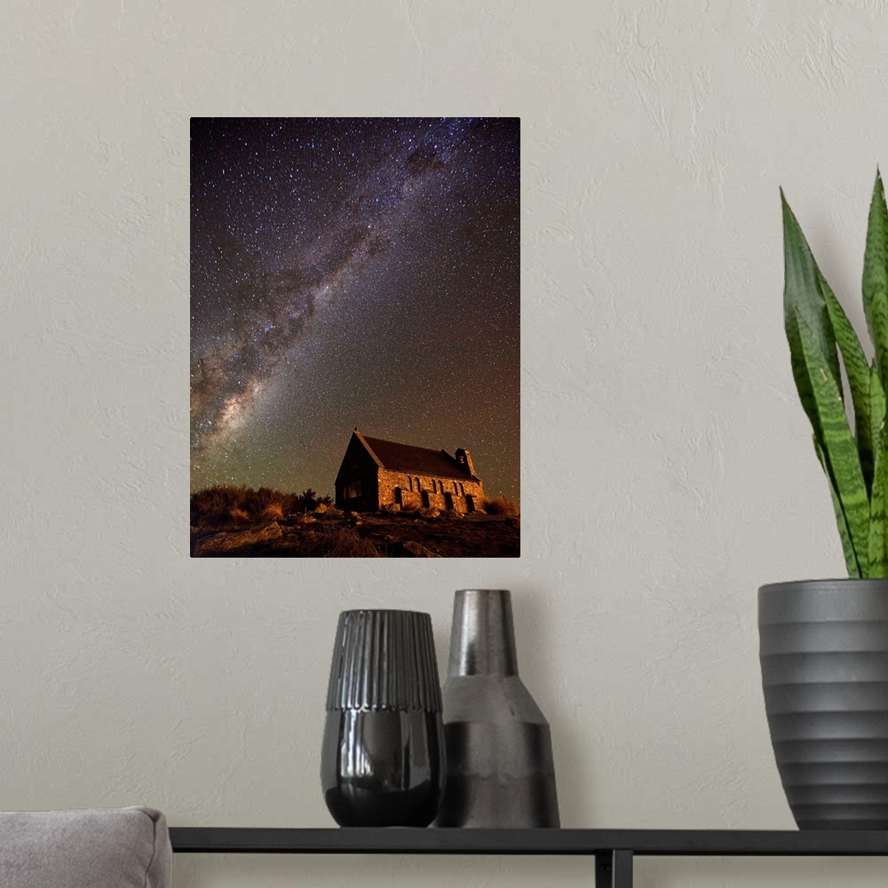 A modern room featuring An old church near Lake Tekapo in New Zealand, under a starry night sky.