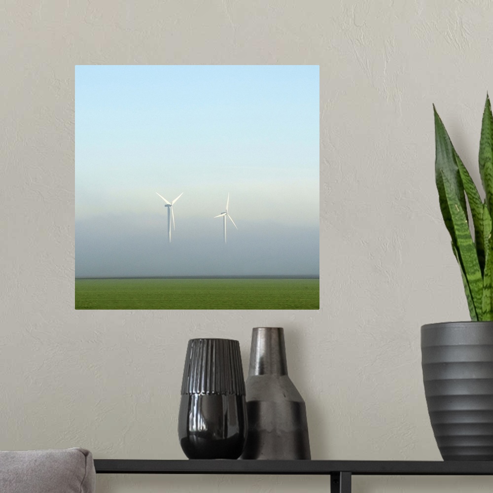 A modern room featuring Two energy turbines appear to float in the air, their bases hidden in mist.