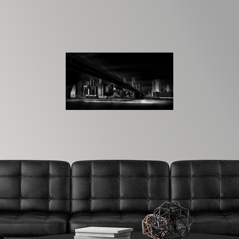 A modern room featuring A dramatic black and white photograph of the New York city skyline with the Brooklyn bridge in th...