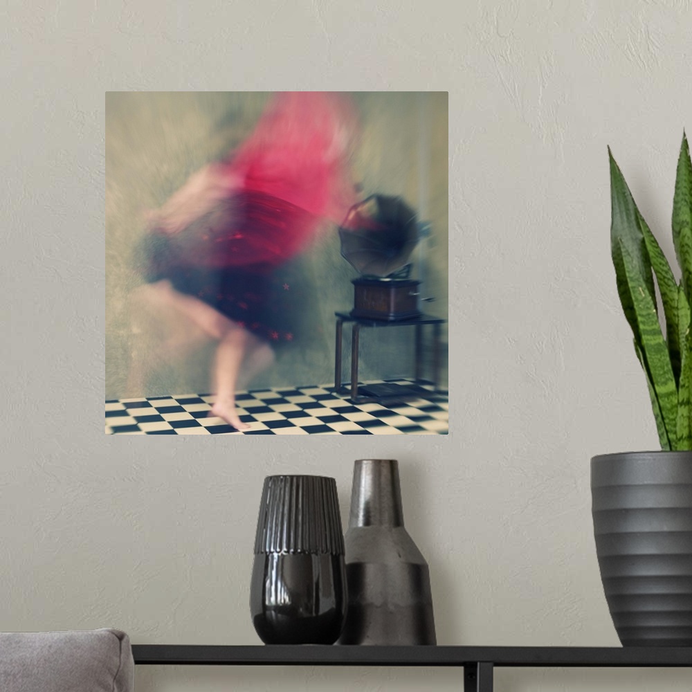 A modern room featuring Blurred motion image of a woman in red dancing to music from a phonograph.