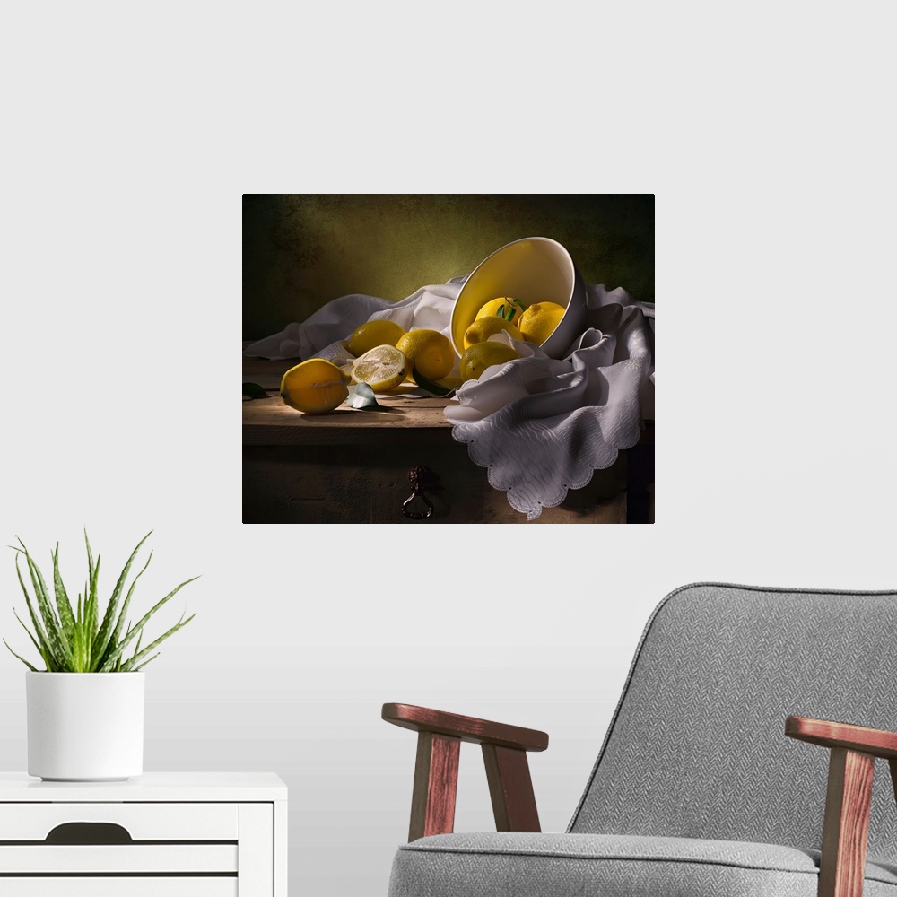 A modern room featuring A bowl of lemons on a white cloth, one split in half.