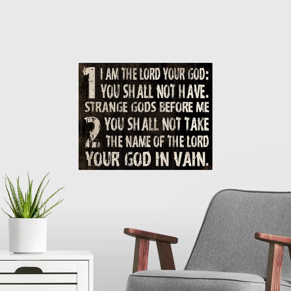 A modern room featuring Religious typography art, with the first two commandments in a weathered, rustic look.
