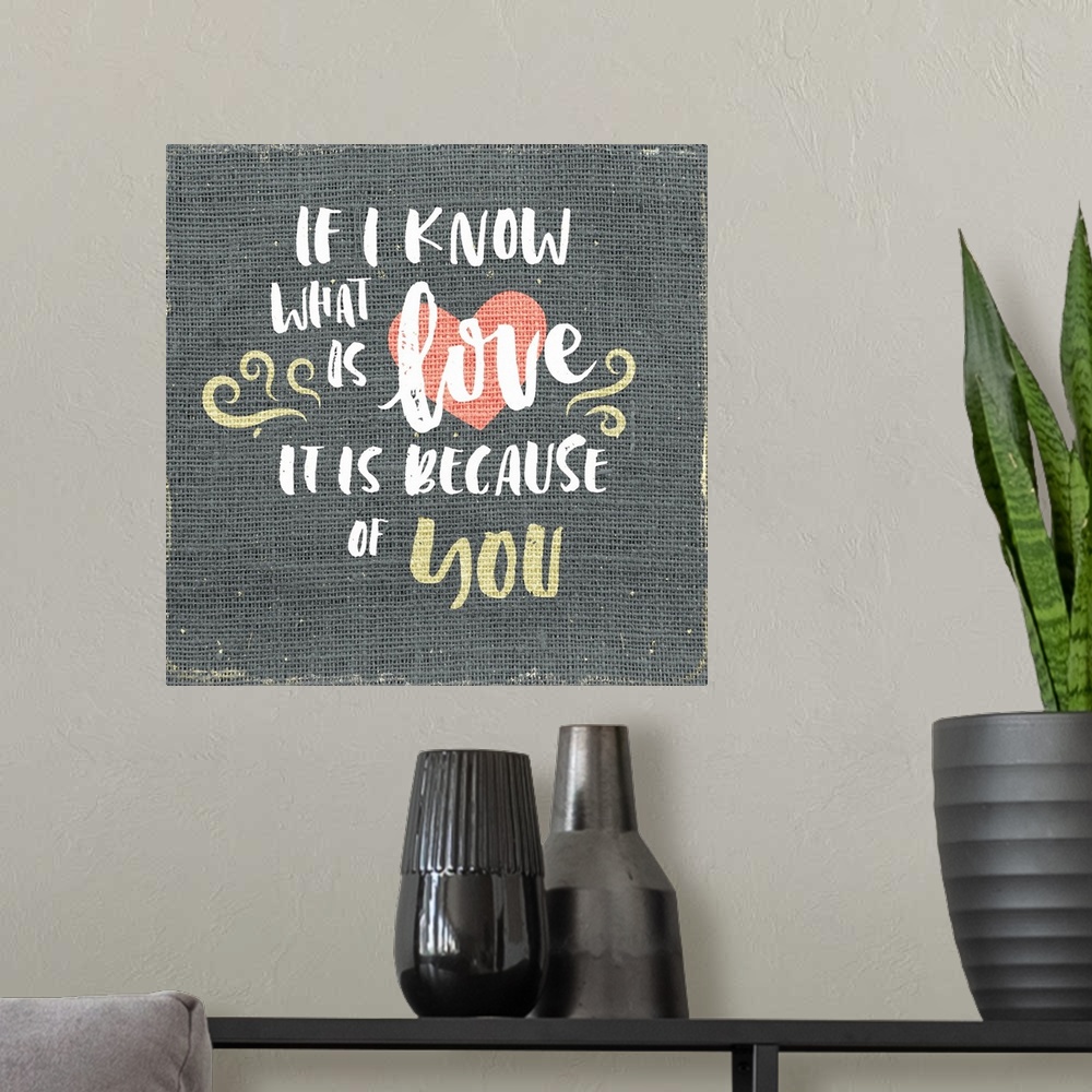 A modern room featuring "If I know what is love is it is because of you" written on burlap.