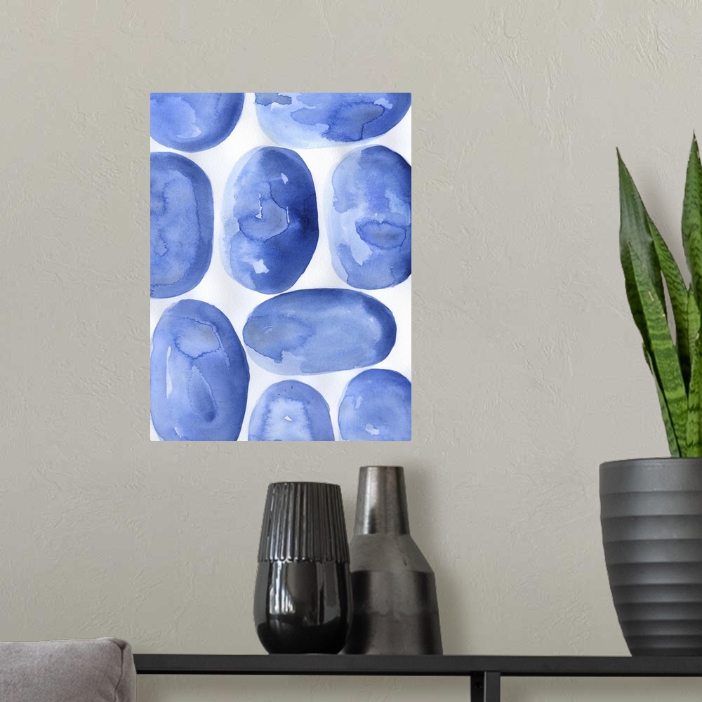 A modern room featuring Abstract artwork of round, blue shapes on white.