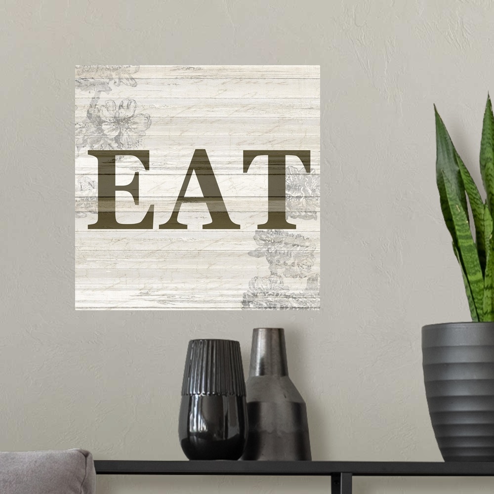 A modern room featuring The word ?eat? on a wood panel background with a faded floral design.�