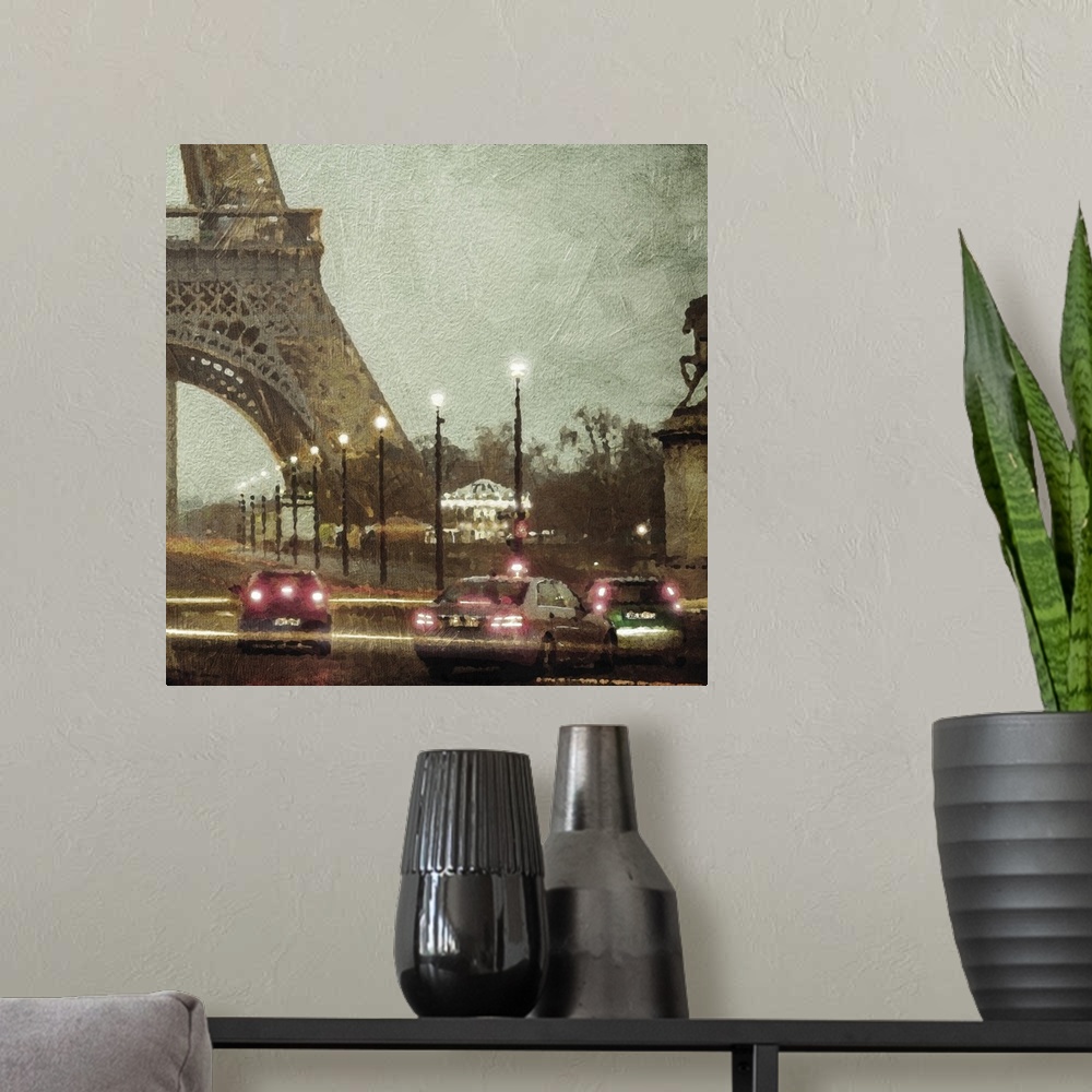 A modern room featuring Traffic in Paris at night at the base of the Eiffel tower.