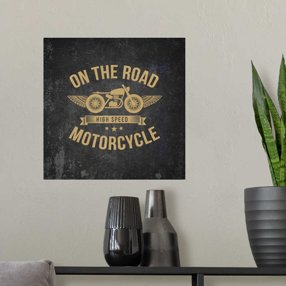 A modern room featuring Gold and black garage sign with a motorcycle and wings design.