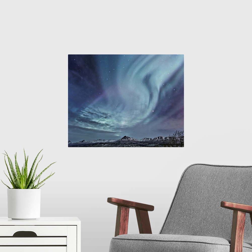 A modern room featuring Northern Lights (aurora borealis) over the Talkeetna Range in South Central Alaska on a sub-zero ...