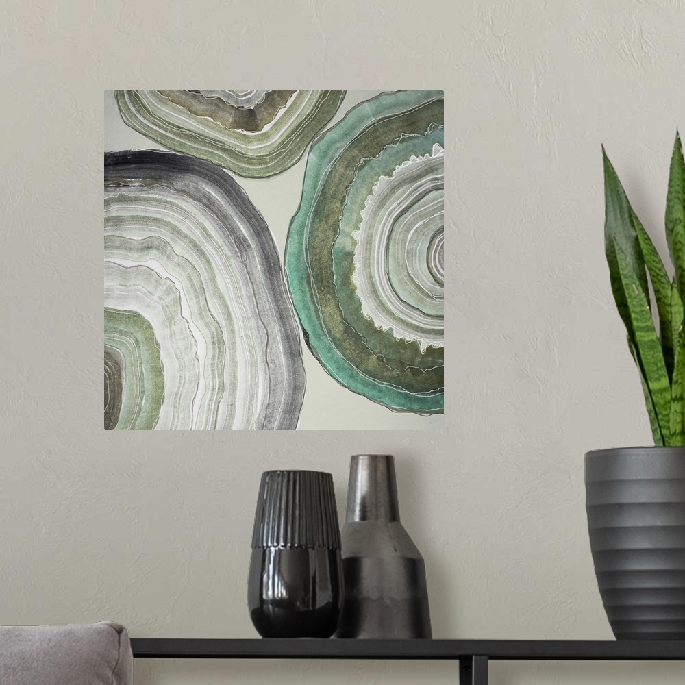 A modern room featuring Contemporary home decor artwork of pale colored geode cross sections against a gray background.