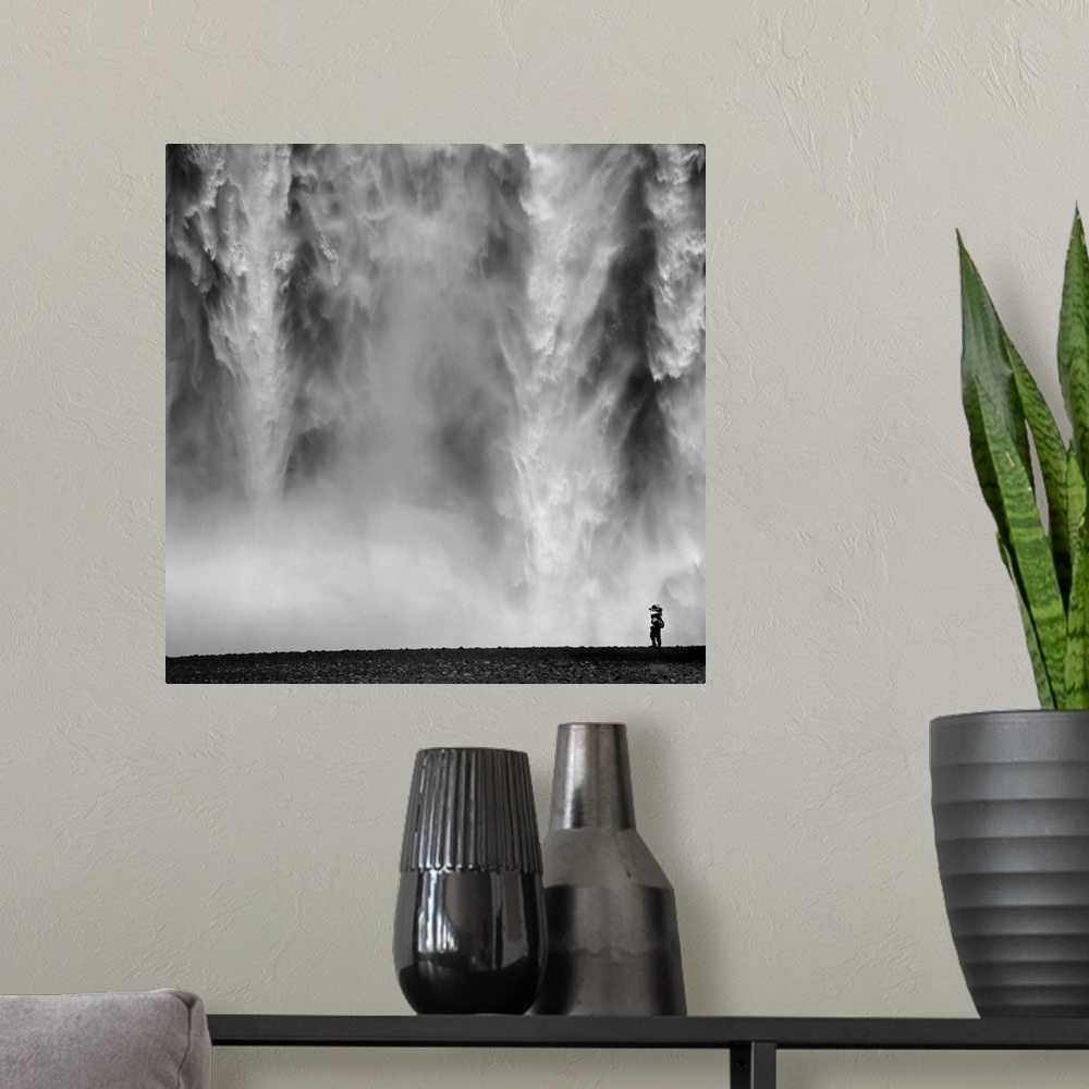 A modern room featuring Black and White Photo of waterfall with person