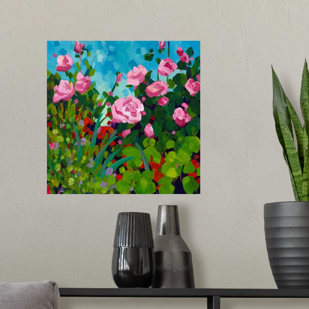 A modern room featuring Pink roses and red flowering geranium painting in front of a blue sky.