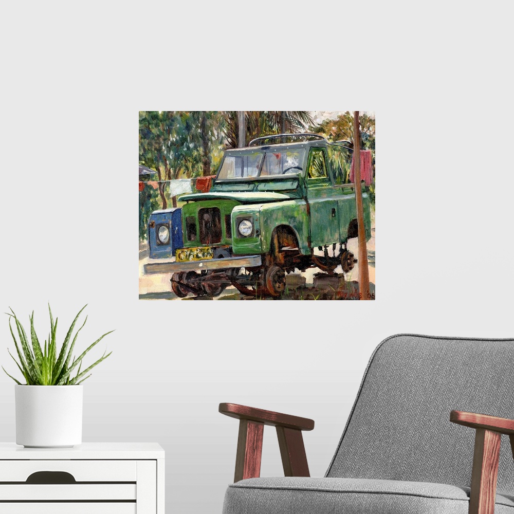 A modern room featuring Oil painting of broken down car sitting on blocks with tropical backdrop.