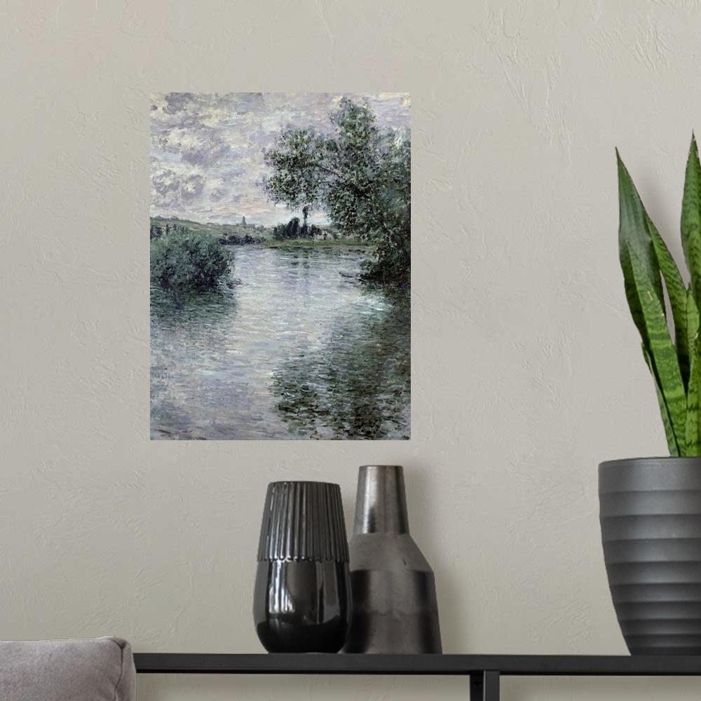 A modern room featuring A classic art piece of a body of water that has trees hanging over it and reflecting in it with l...