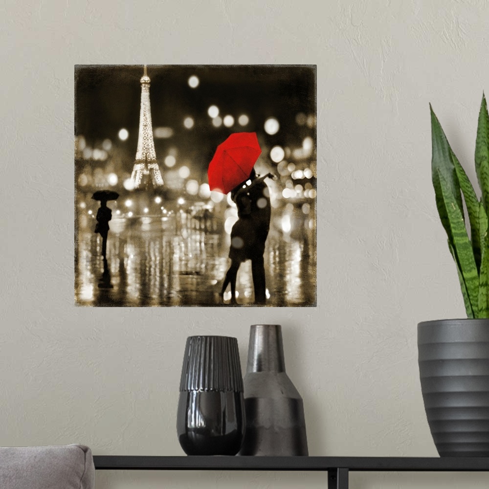 A modern room featuring Square art with a couple kissing under a red umbrella and the Eiffel Tower lit up in the background.
