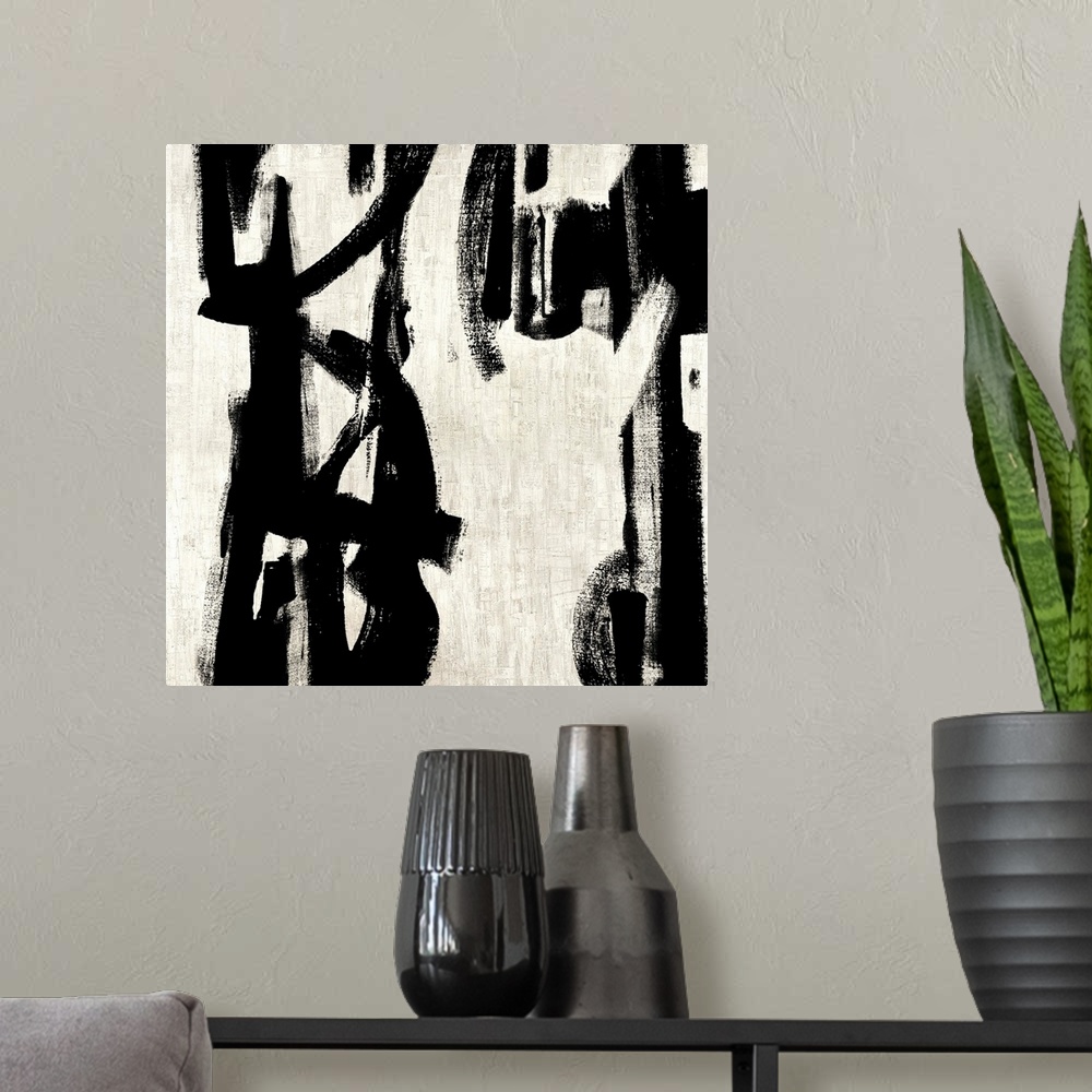 A modern room featuring Square abstract painting in black and white with vertical designs.
