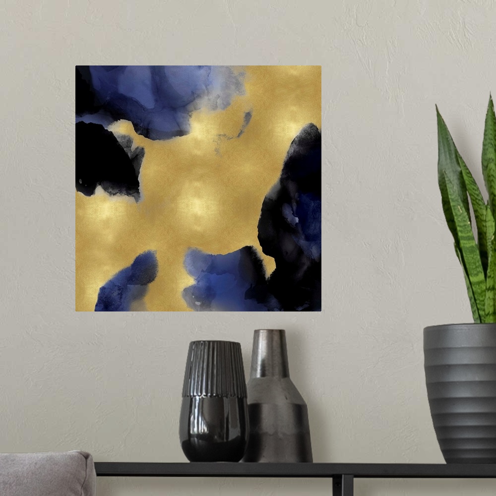 A modern room featuring Abstract painting with indigo hues splattered together on a gold background.