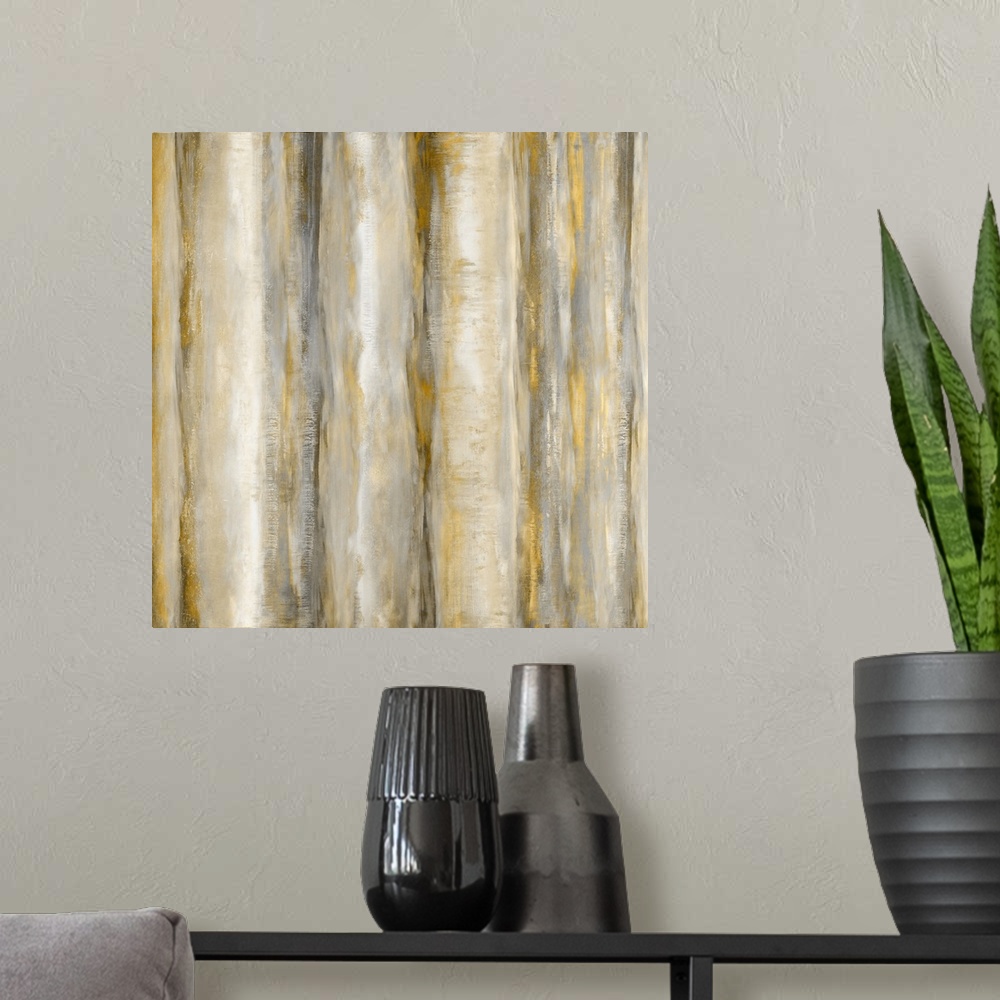A modern room featuring Square abstract painting with bands of metallic gold and silver running vertically across the can...