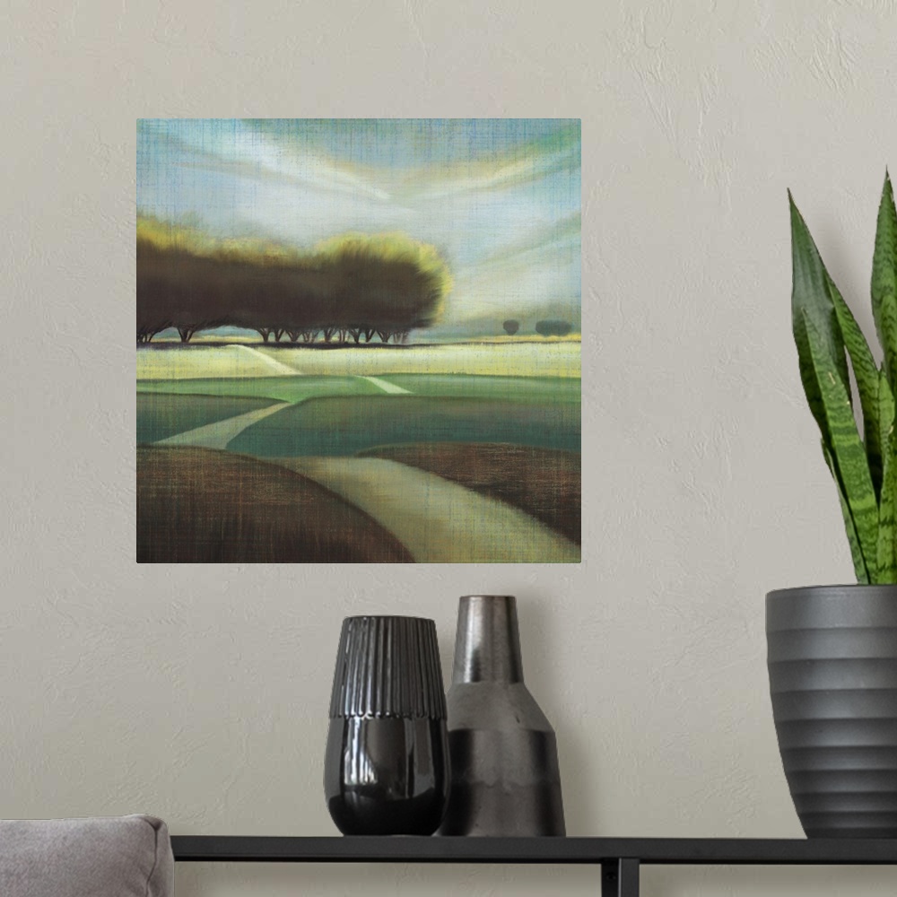 A modern room featuring Contemporary artwork of large trees in a hilly landscape with a narrow road.
