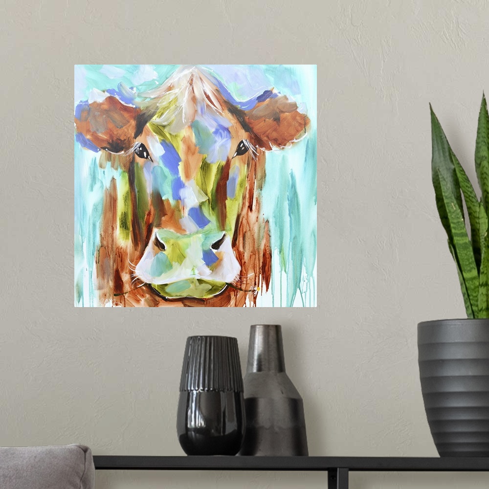 A modern room featuring A contemporary square painting of the face of a cow done in multiple colors with strokes of blue ...