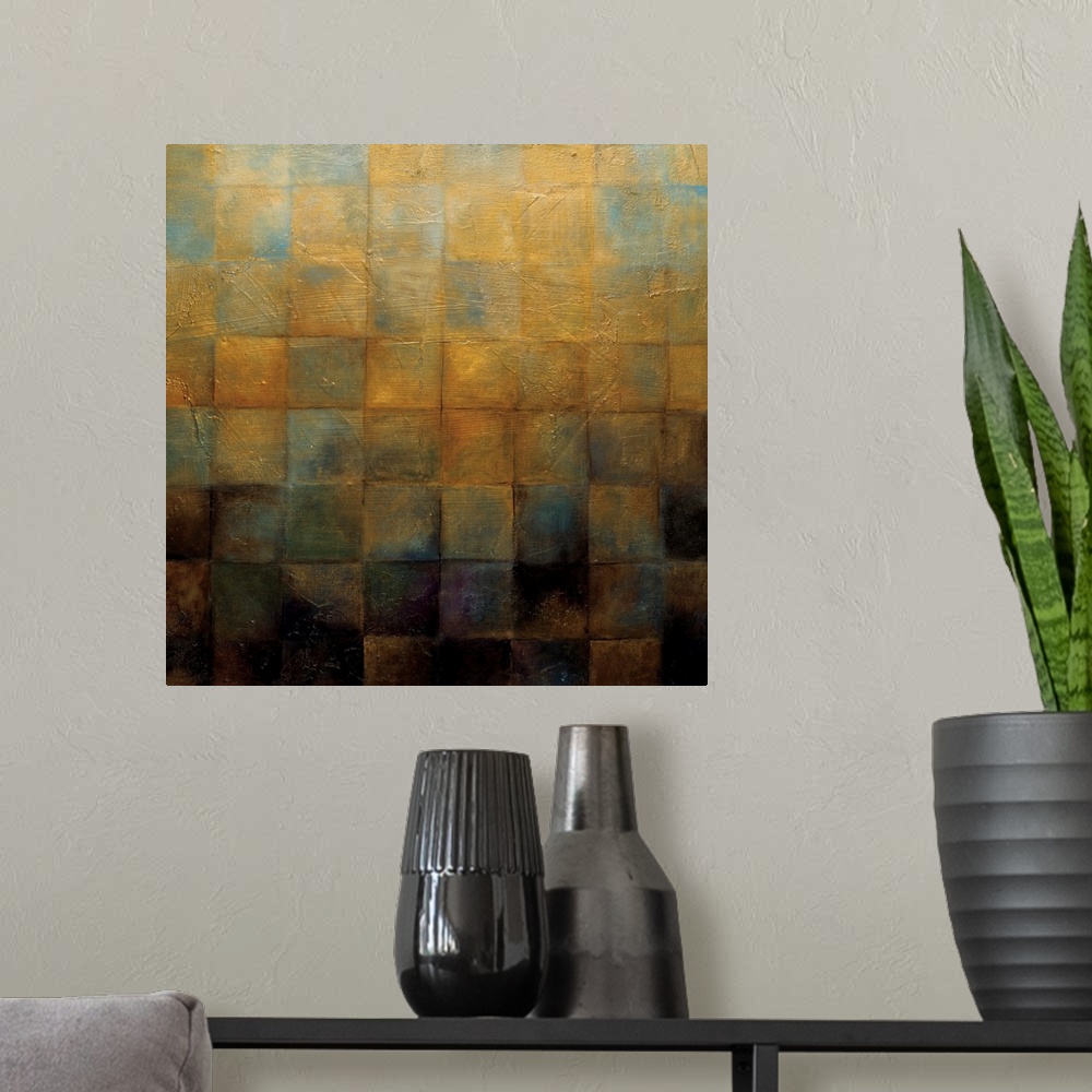 A modern room featuring Square painting of varies colors on earth tones in a square gradient style.