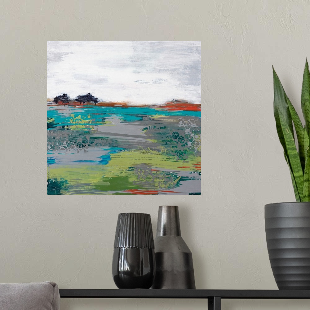 A modern room featuring A modern abstract landscape of a field with a few trees and a grey sky.