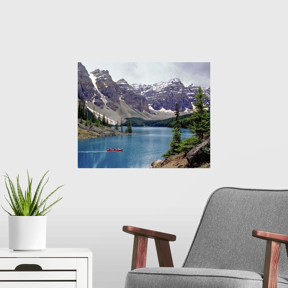 A modern room featuring Canada, Alberta, Moraine Lake. A canoe glides across beautiful Moraine Lake in the Valley of the ...