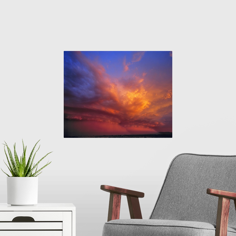 A modern room featuring USA, Nevada. Storm clouds color with the setting sun over the Nevada desert.