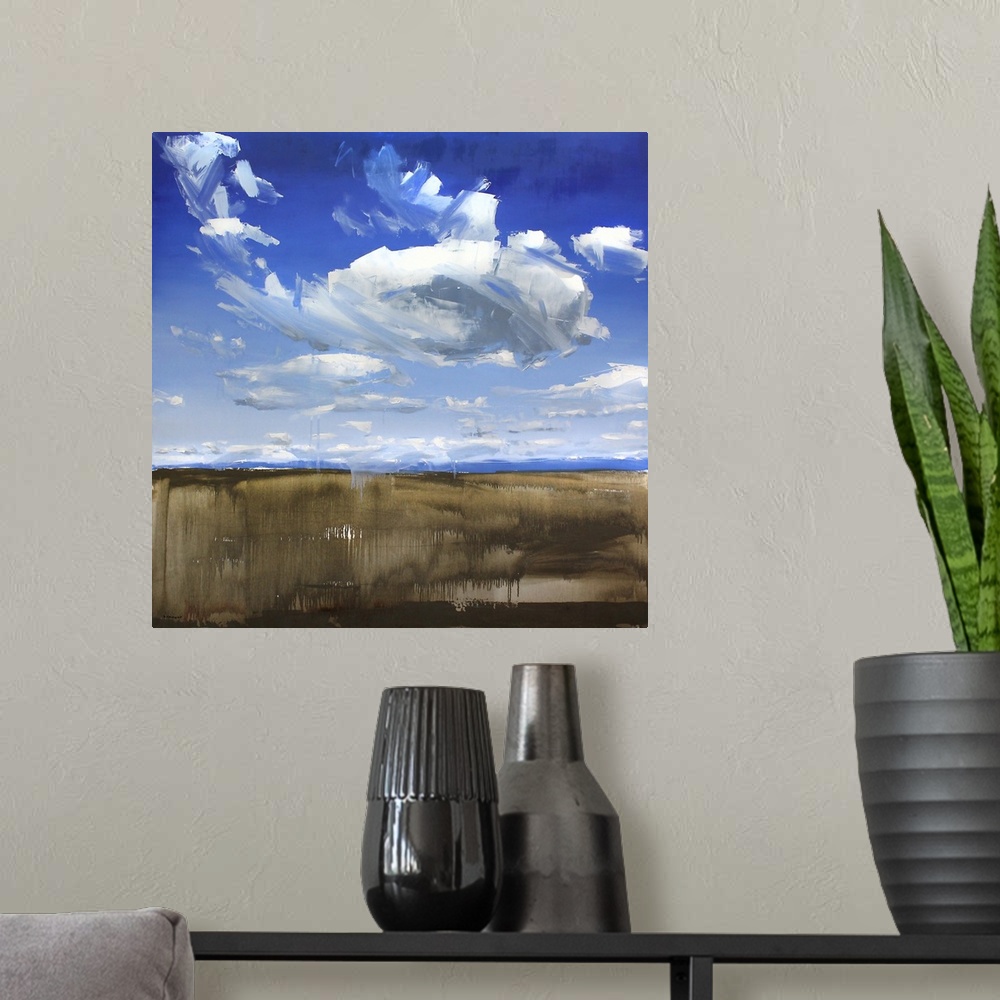 A modern room featuring A contemporary painting of a green field under a sky filled with gray clouds.